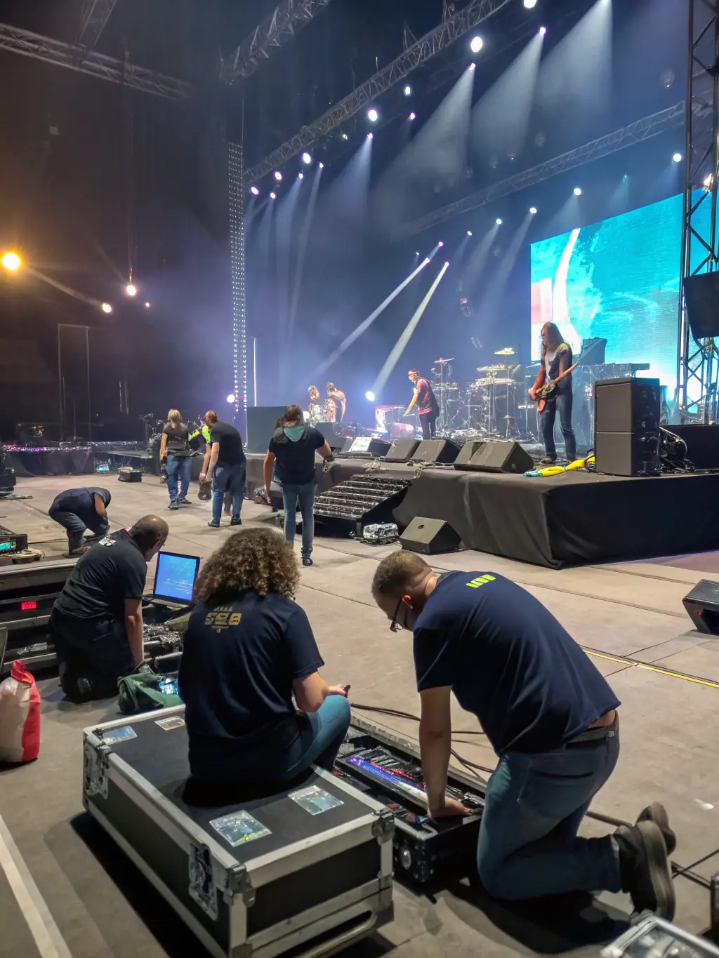 A photo of volunteers setting up for a concert, highlighting the community involvement in supporting the organization's activities.
