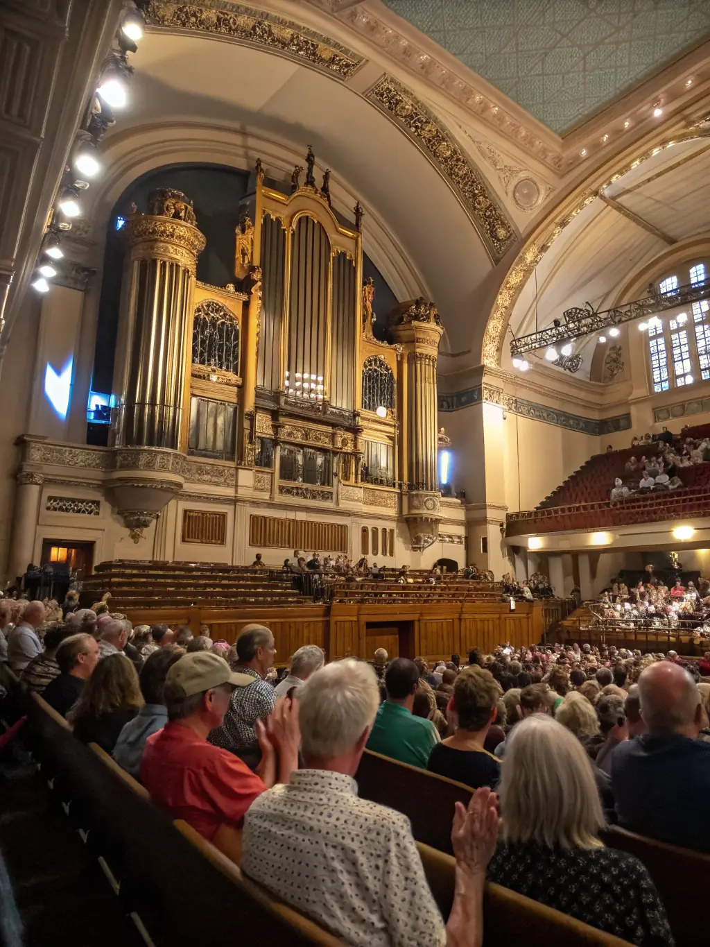 A photograph capturing the grandeur of a recent organ concert, showcasing the organist in action and the captivated audience in the pews.