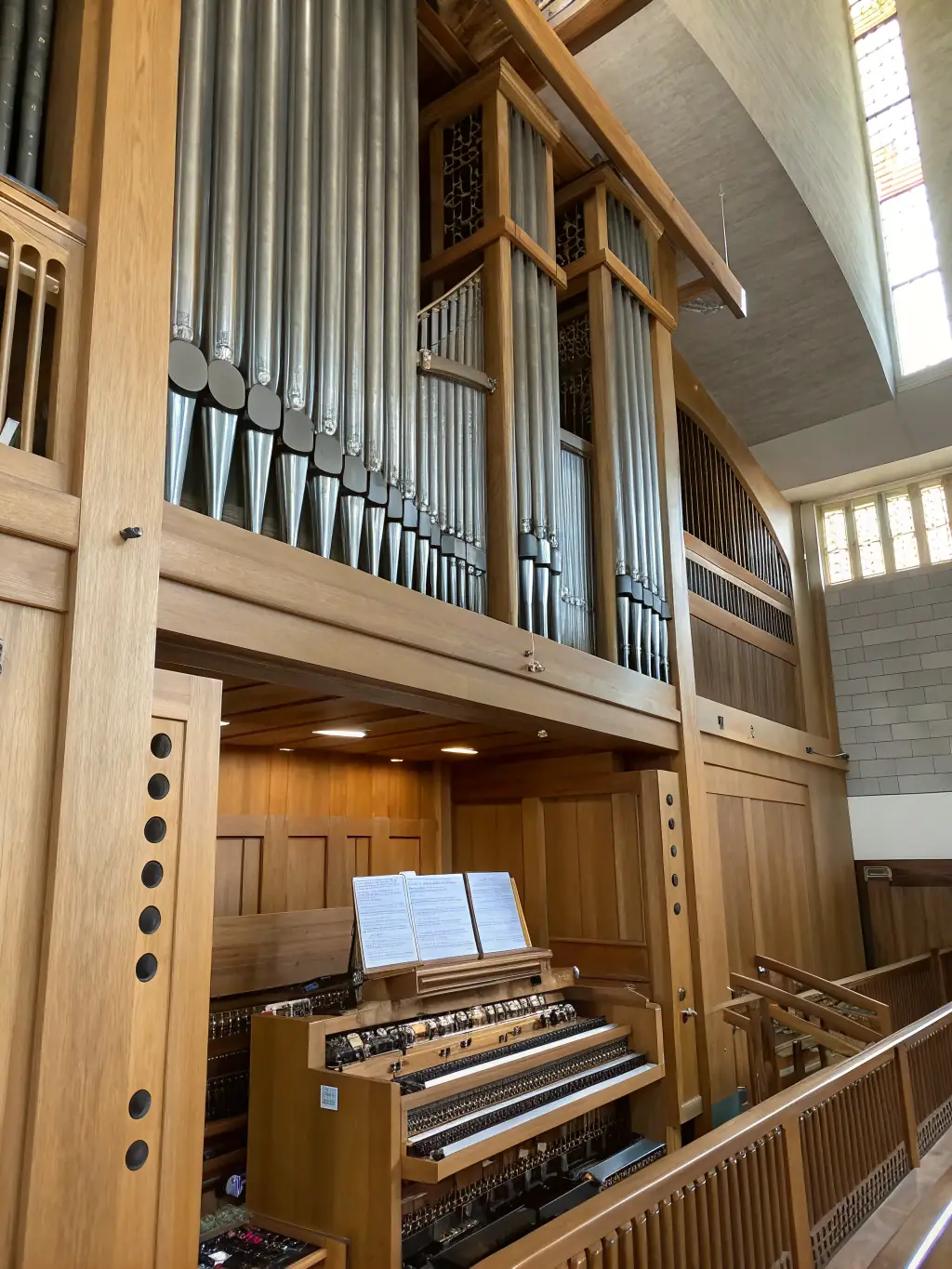 A close-up shot of an organ being restored, highlighting the intricate details of the instrument and the dedication of the restoration team.